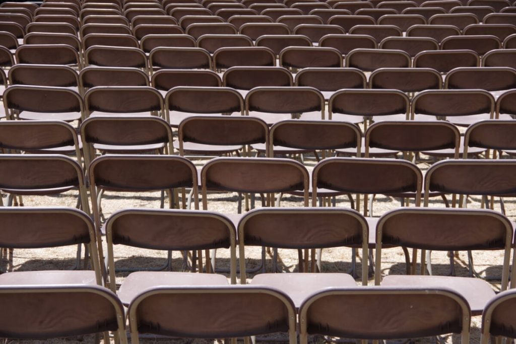 Rows of metal folding chairs.
