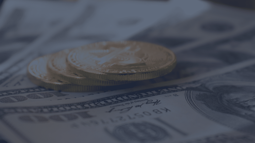 Coins sitting on top of dollar bills